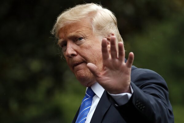 
              FILE - In this Tuesday, July 24, 2018, file photo, President Donald Trump waves as he walks on the South Lawn after stepping off Marine One at the White House, in Washington. Trump was recorded by his longtime personal lawyer discussing a potential payment for a former Playboy model's account of having an affair with him, and at one point can be heard saying "pay with cash." (AP Photo/Alex Brandon, File)
            