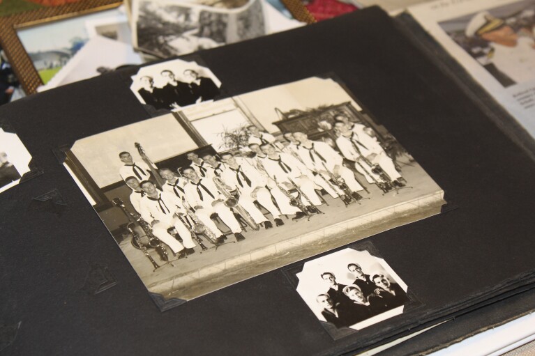 A photo album in the home of Pearl Harbor survivor Ira "ike" A vintage group photo of the U.S. Navy Band shows the scab in Beaverton, Oregon, on Monday, Nov. 20, 2023.  Shaub, now 103, played tuba in the band and remained close with his bandmates for decades after the war.  Schaub plans to return to Pearl Harbor on the 82nd anniversary of the attack to remember the more than 2,300 soldiers who died.  (AP Photo/Claire Rush)