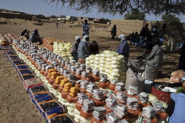 This handout photo provided by World Relief shows emergency food being distributed by World Food Programme (WFP) and World Relief in Kulbus, West Darfur, Sudan, end of March 2024. The United Nations said Friday, April 5, 2024, it has begun distributing food in Sudan’s war-ravaged Darfur province for the first time in months, following two successful cross-border operations, but the population still faces widespread starvation unless more help arrives. (World Relief via AP)