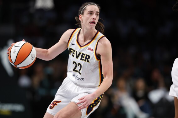 Indiana Fever guard Caitlin Clark (22) dribbles the ball against the New York Liberty during the first half of a WNBA basketball game, Saturday, May 18, 2024, in New York. (AP Photo/Noah K. Murray)