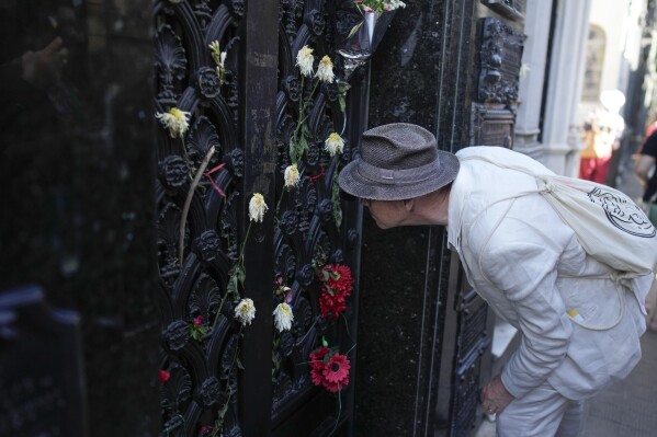 A tourist looks at the mausoleum containing the remains of Argentina's former first lady Maria Eva Duarte de Peron, better known as Eva Peron or Evita, at the Recoleta Cemetery in Buenos Aires, Argentina, on Tuesday, Feb. 13, 2024.  (AP Photo/Natacha Pisarenko)