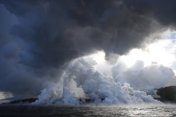
              FILE - In this May 20, 2018 file photo, plumes of steam rise as lava enters the ocean near Pahoa, Hawaii. An explosion sent lava flying through the roof of a tour boat off Hawaii's Big Island, injuring at least 13 people Monday, July 16, 2018, officials said. The people were aboard a tour boat that takes visitors to see lava from an erupting volcano plunge into the ocean. (AP Photo/Jae C. Hong, File)
            
