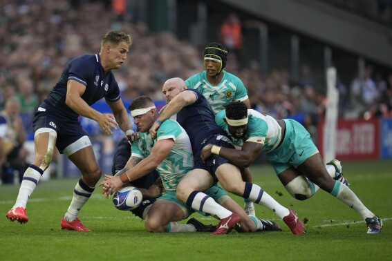 South Africa's Malcom Marx, 2nd left, drops the ball as he is tackled by Scotland's David Cherry during the Rugby World Cup Pool B match between South Africa and Scotland at the Stade de Marseille in Marseille, France, Sunday, Sept. 10, 2023. (AP Photo/Daniel Cole)