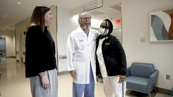 Pig Kidney Recipient Towana Looney stands with the transplant surgeon. Dr. Jamelock, left, US Administration of Health Resources & Services, and Dr. Robert Montgomery of Nyu Langone Health, Nyu Langone Health, New York City, December 10, 2024. (AP photo/Shellby Rum)