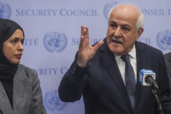 Palestinian United Nations Ambassador Riyad Mansour, right, speaks during a press conference ahead of a U.N. General Assembly vote on a resolution calling for a cease fire between Israel and Hamas in Gaza, Tuesday, Dec. 12, 2023, at U.N. headquarters. (AP Photo/Bebeto Matthews)