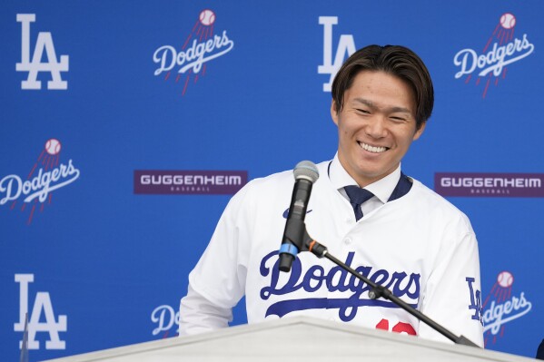 Yoshinobu Yamamoto smiles during his introduction as a new member of the Los Angeles Dodgers baseball team Wednesday, Dec. 27, 2023, in Los Angeles. (AP Photo/Ashley Landis)