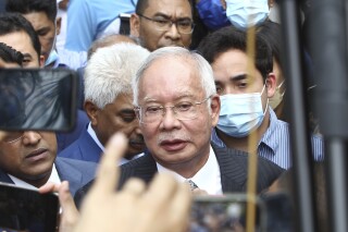 FILE - Former Malaysian Prime Minister Najib Razak, center, speaks to supporters outside at Court of Appeal in Putrajaya, Malaysia Tuesday, Aug. 23, 2022. Two managers of a Saudi oil exploration company were going on trial Tuesday, April 2, 2024, in Switzerland for alleged fraud and money laundering in a scandal years ago linked to a Malaysian sovereign wealth fund that the U.S. Justice Department once described as the “biggest kleptocracy case” ever.(AP Photo, File)