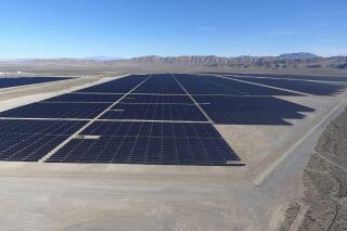 FILE - In this Dec. 11, 2017, file photo, solar arrays line the desert floor of the Dry Lake Solar Energy Zone as part of the 179 megawatt Switch Station 1 and Switch Station 2 Solar Projects north of Las Vegas. The Biden administration on Tuesday, Dec. 21, 2021, issued a solicitation for interest in developing solar power on public lands in Nevada, New Mexico and Colorado. (Michael Quine/Las Vegas Review-Journal via AP, File)