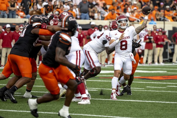 Oklahoma quarterback Dillon Gabriel (8) passes a touchdown in the first half of an NCAA college football game against Oklahoma State Saturday, Nov. 4, 2023, in Stillwater, Okla. (AP Photo/Mitch Alcala)