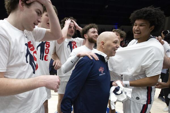 Saint Mary's head coach Randy Bennett, center, is congratulated by his players after notching his 500th career coaching victory, with a 68-59 victory over San Francisco in an NCAA college basketball game, Thursday, Feb. 2, 2023, in Moraga, Calif. (AP Photo/D. Ross Cameron)