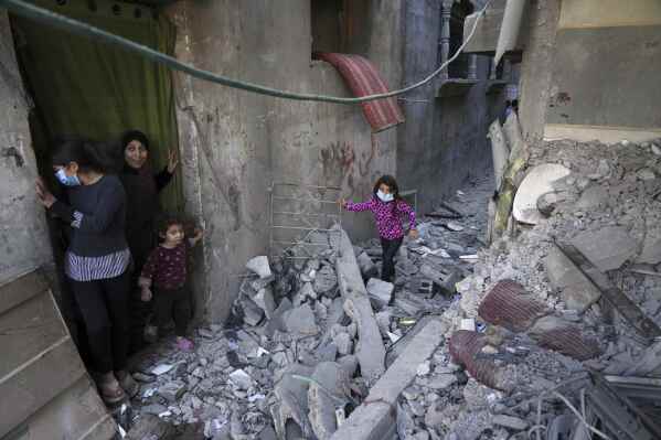 Palestinians inspect the rubble of homes destroyed by Israeli airstrikes in Jabalia, northern Gaza Strip, on Wednesday, May 14, 2025. According to local hospitals, 48 people were killed in the strikes, including 22 children. (AP Photo/Jehad Alshrafi)