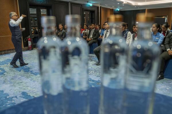 Ganesh Iyer, managing partner of Zero Percent India, which includes Veen Waters, speaks during a workshop on water at the Ritz-Carlton hotel in Pune, India, Thursday, May 4, 2023. Iyer, a certified water sommelier, hoped the session would inspire his students to sell more bottles of his brand to hotel guests. But he also sprinkled in messages about respecting water and conserving it. (AP Photo/Dar Yasin)