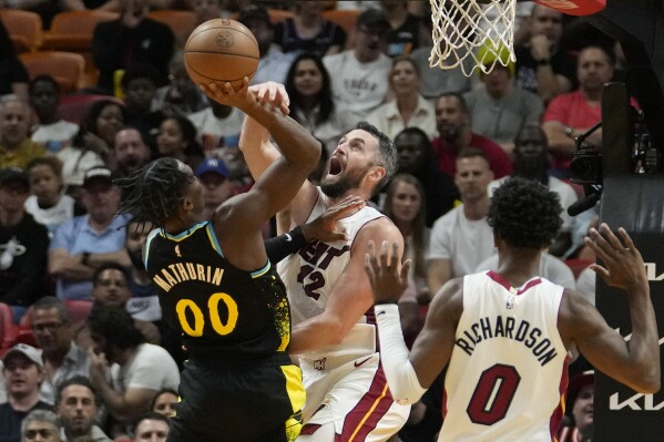 Indiana Pacers guard Bennedict Mathurin (00) is fouled by Miami Heat forward Kevin Love, center, during the first half of an NBA basketball game Saturday, Dec. 2, 2023, in Miami. (AP Photo/Lynne Sladky)