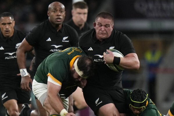 FILE - New Zealand's Ethan de Groot, right, is challenged during the rugby union international match between South Africa and New Zealand, at Twickenham stadium in London, Aug. 25, 2023. New Zealand prop Ethan de Groot has been suspended for three Rugby World Cup games for his red card against Namibia. He will miss the All Blacks’ last Pool A games in Lyon against Italy on Sept. 29 and Uruguay on Oct. 5. (AP Photo/Alastair Grant, File)
