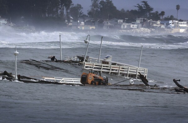 Part of a wharf and other debris floats in the ocean Monday, Dec. 23, 2024, in Santa Cruz, Calif. (Shmuel Thaler/The Santa Cruz Sentinel via AP)
