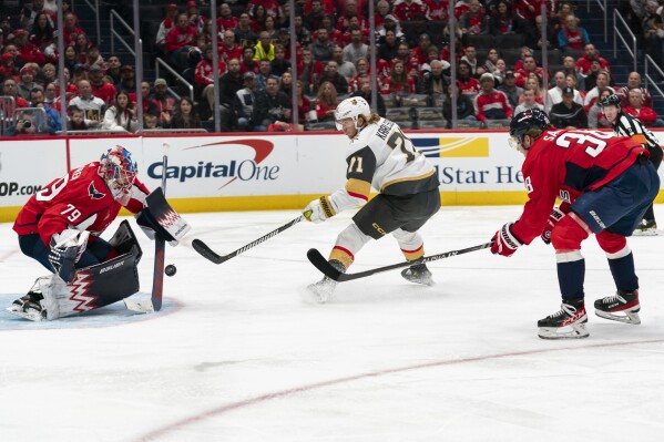 Washington Capitals goaltender Charlie Lindgren (79) defends the net against Vegas Golden Knights center William Karlsson (71) in the second period of an NHL hockey game, Tuesday, Nov. 14, 2023, in Washington. (AP Photo/Stephanie Scarbrough)