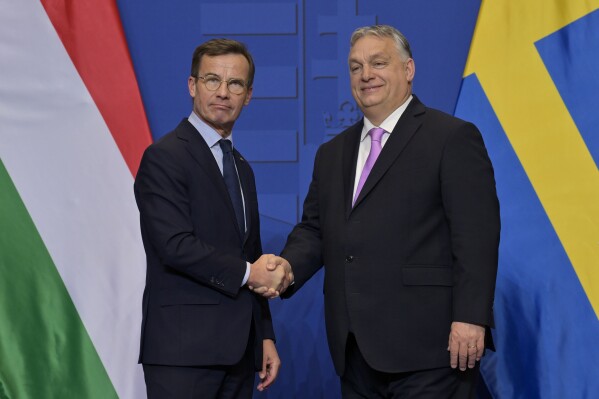 FILE - Sweden's Prime Minister Ulf Kristersson, left, shakes hands with his Hungarian counterpart Viktor Orban at the Carmelite Monastery in Budapest, Hungary, Friday, Feb 23, 2024. Sweden’s bid to join NATO — held up for almost two years — cleared its last hurdle when Hungary gave its go-ahead Monday, Feb. 26, 2024, to let the Nordic country into the alliance. (AP Photo/Denes Erdos, File)