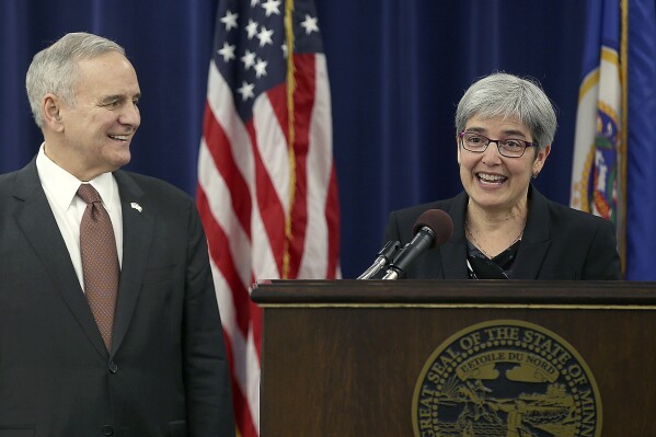 Judge Margaret Chutich introduces herself after being appointed by Gov. Mark Dayton, left, during a news conference, Jan. 22, 2016, at the Veterans Services Building in St. Paul, Minn. Chutich announced her retirement Tuesday, Jan. 16, 2024. Democratic Gov. Tim Walz said in a Tuesday statement that Chutich has been "a trailblazer as Minnesota’s first openly gay justice." (Elizabeth Flores/Star Tribune via AP)