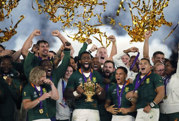 FILE  - In this Saturday, Nov. 2, 2019 file photo, South African captain Siya Kolisi holds the Webb Ellis Cup aloft after South Africa defeated England to win the Rugby World Cup final at International Yokohama Stadium in Yokohama, Japan. The South African government maintained a ban on all contact sports competitions on Saturday, May 30, 2020 because of the coronavirus, meaning the country's professional rugby teams and its world champion Springboks will remain out of action for now. (AP Photo/Christophe Ena, File)
