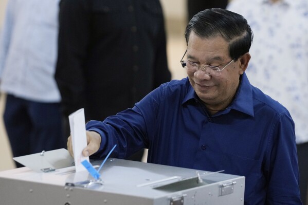 Cambodian Prime Minister Hun Sen of the Cambodian People's Party (CPP) drops a ballot into a box for voting at a polling station at Takhmua in Kandal province, southeast Phnom Penh, Cambodia, Sunday, July 23, 2023. Cambodians go to the polls Sunday with incumbent Prime Minister Hun Sen and his party all but assured a landslide victory thanks to the effective suppression and intimidation of any real opposition that critics say has made a farce of democracy in the Southeast Asian nation. (AP Photo/Heng Sinith)