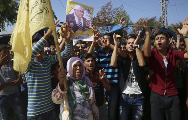                                                         Fatah supporters chant slogans while other elevate a portray of Palestinian president Mahmoud Abbas, while looking out forward to the Top Minister Rami Hamdallah, on the Palestinian facet of the Beit Hanoun border crossing within the northern Gaza Strip, Monday, Oct. 2, 2017. Hamdallah is in Gaza for basically the most plucky attempt but to cease the 10-365 days rift between rival Palestinian factions Fatah and Hamas. (AP Photograph/Adel Hana)            