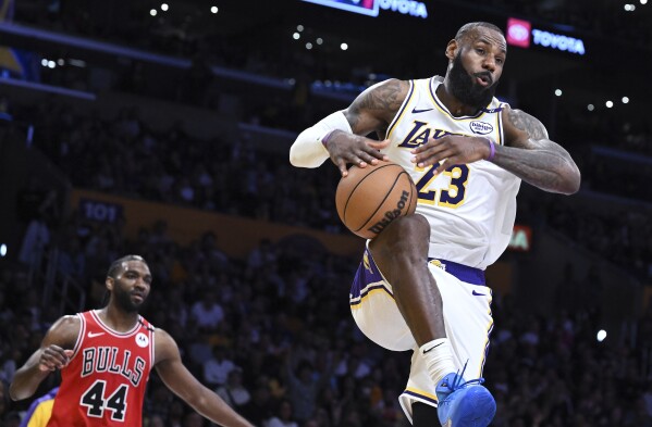 Los Angeles Lakers forward LeBron James (23) dunks in front of of Chicago Bulls forward Patrick Williams (44) in the second half of an NBA basketball game Saturday, March 22, 2025, in Los Angeles. (AP Photo/Wally Skalij)