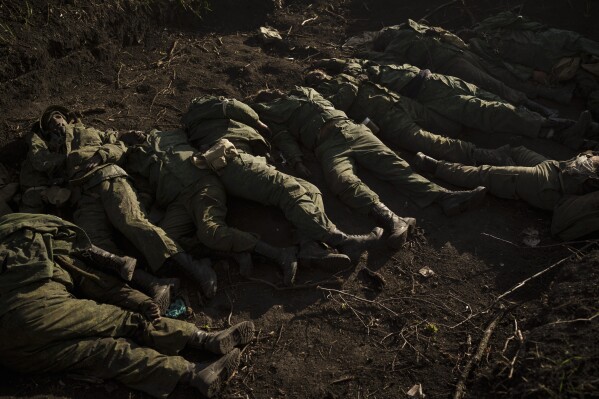 EDS NOTE: GRAPHIC CONTENT - The bodies of 11 Russian soldiers lay in the village of Vilkhivka, recently retaken by Ukraininan forces near Kharkiv, Ukraine, Monday, May 9, 2022. (AP Photo/Felipe Dana)