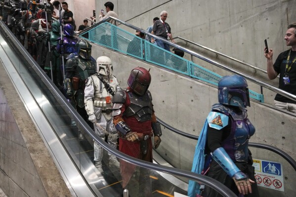Star Wars fans in different creations of the Boba Fett uniforms attend a fan convention, the Star Wars Celebration in Chiba, near Tokyo, Friday, April 18, 2025. (AP Photo/Hiro Komae, File)