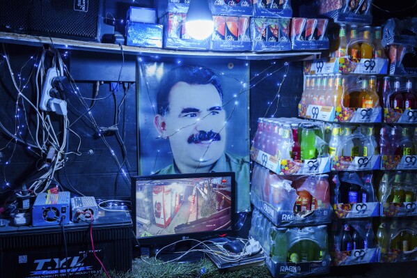 A picture of Abdullah Ocalan, the imprisoned leader of Turkey's banned Kurdistan Workers' Party, or PKK, is displayed inside a shop in the northern Syrian city of Qamishli that is controlled by the US-backed and Kurdish-led Syrian Democratic Forces, Sunday, Jan. 26, 2025. (AP Photo/Bernat Armangue)