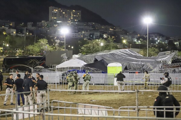 Security forces stand around a stage that collapsed due to a gust of wind during an event attended by presidential candidate Jorge Álvarez Máynez in San Pedro Garza García, on the outskirts of Monterrey, Mexico, Wednesday, May 22, 2024. President Andres Manuel Lopez Obrador confirmed that multiple people were killed and at least a dozen were injured. (AP Photo/Alberto Lopez)