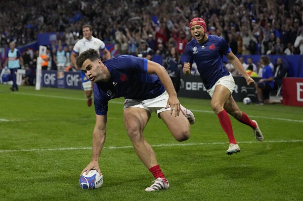 France's Damian Penaud scores a try during the Rugby World Cup Pool A match between France and Italy at the OL Stadium in Lyon, France, Friday, Oct. 6, 2023. (AP Photo/Pavel Golovkin)
