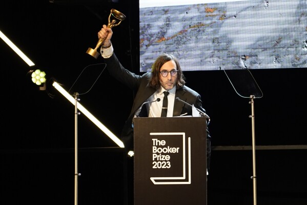 Paul Lynch, Winner of the 2023 Booker Prize celebrates shortly after the announcement in London, Sunday, Nov. 26, 2023. The Booker Prize is awarded to the best sustained work of fiction written in English and published in the UK and Ireland, in the opinion of the judges. Lynch won with his book 'Prophet Song', a dystopian vision of Ireland in the grips of totalitarianism. (AP Photo/Alberto Pezzali)