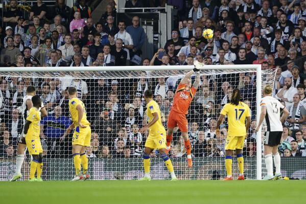 Everton goalkeeper Jordan Pickford saves a shot during the English Premier League soccer match between Fulham and Everton at Craven Cottage, in London, Saturday, Oct. 29, 2022. (Zac Goodwin/PA via AP)