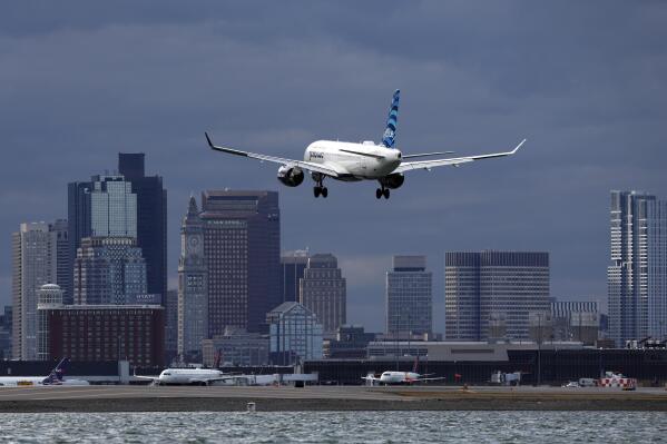 FILE - A JetBlue plane lands at Logan International Airport, Thursday, Jan. 26, 2023, in Boston. Federal officials are investigating a string of close calls between planes, including one this week at Logan. (AP Photo/Michael Dwyer, File)