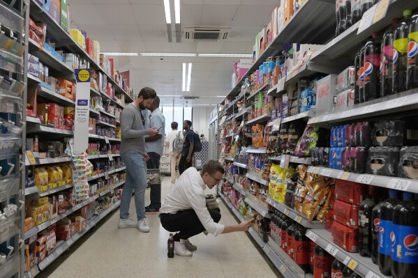 FILE - Shoppers buy food in a supermarket in London, on Aug. 17, 2022. Price rises in the U.K. eased by more than anticipated in the year to February, official figures showed Wednesday, March 20, 2024, raising expectations that the Bank of England may start cutting interest rates in the next few months. (AP Photo/Frank Augstein, File)