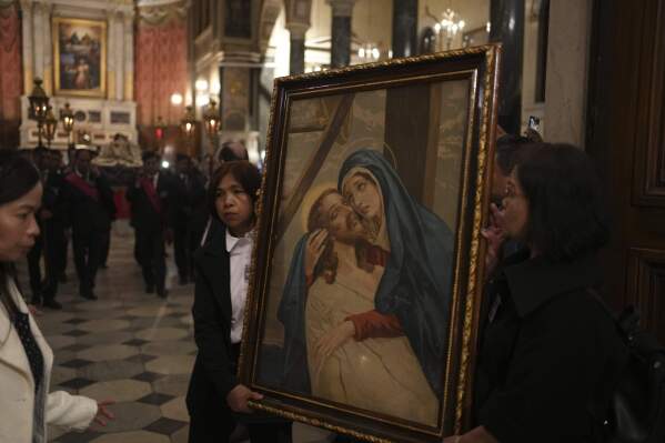 Greek Catholic believers and foreigners who live in Greece attend the Epitaph Procession at the Catholic Cathedral Basilica of St Dionysius the Areopagite in Athens, Greece, Good Friday, April 18, 2025. (AP Photo/Thanassis Stavrakis)