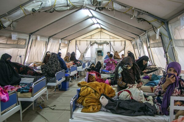 In this handout photo released by MSF Afghanistan, injured people receive treatment after a powerful earthquake in Herat province, western of Afghanistan, Sunday, Oct. 15, 2023. (MSF Afghanistan via AP)