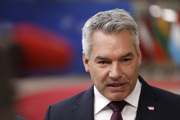 FILE - Austria's Chancellor Karl Nehammer speaks with the media as he arrives for a EU Summit in Brussels, Thursday, March 21, 2024. The arrest in recent days of a former Austrian intelligence officer on serious allegations of spying for Russia suggests that Austria needs to boost its security to thwart Russian infiltration, Austrian Chancellor Karl Nehammer said Monday, April 1, 2024. (AP Photo/Omar Havana, File)