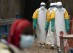 FILE— In this July 16, 2019 photo, health workers dressed in protective gear begin their shift at an Ebola treatment center in Beni, Congo DRC. Internal documents obtained by The Associated Press show that the World Health Organization has paid $250 each to at least 104 women in Congo who say they were sexually abused or exploited by Ebola outbreak responders. That amount is less than what some U.N. officials are given for a single day's expenses when working in Congo. (AP Photo/Jerome Delay, File)