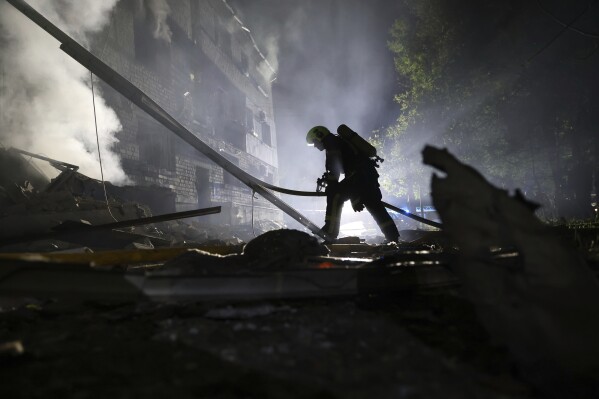 A rescuer works on a site of a residential building destroyed by a Russian strike in Zaporizhzhia, Ukraine, Thursday, May 1, 2025. (AP Photo/Kateryna Klochko)