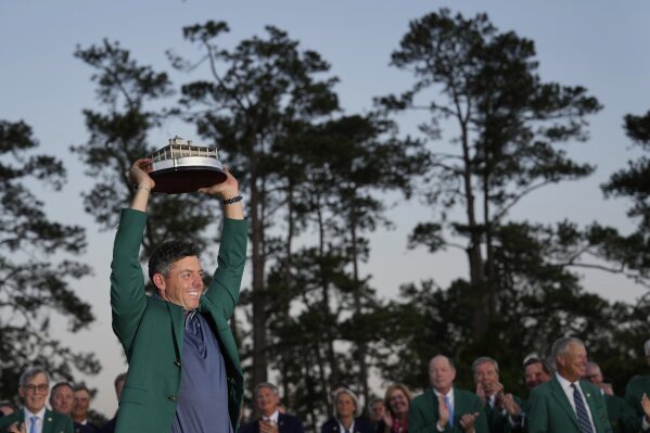 Winner Rory McIlroy, of Northern Ireland, holds the trophy at the Masters golf tournament, Sunday, April 13, 2025, in Augusta, Ga. (AP Photo/David J. Phillip)