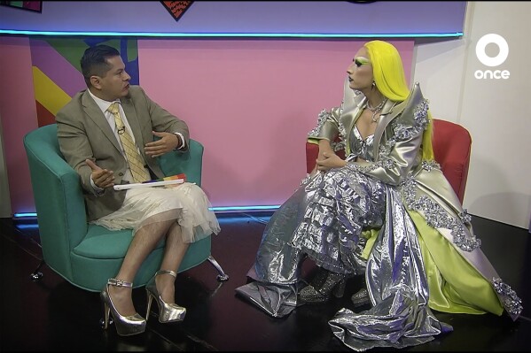 In this frame grab taken from video provided by Canal Once, Amanda, right, the first-ever drag queen to host a news program for Mexican TV, interviews magistrate Ociel Baena, the first openly nonbinary person in Latin America to hold a judicial position, on the “La Verdrag” news program, in Mexico City, Thursday, Oct. 26, 2023. Baena was found dead on Nov. 13, 2023, next to their partner in their home in the central Mexican state of Aguascalientes. (Canal Once via AP)