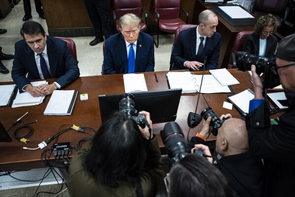 Former President Donald Trump, flanked by attorneys Todd Blanche and Emil Bove, appears at Manhattan criminal court during jury selection in New York, Thursday, April 18, 2024. (Jabin Botsford/The Washington Post via AP, Pool)