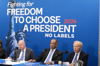 FILE - No Labels leadership and guests from left, Dan Webb, National Co-Chair Dr. Benjamin F. Chavis, and founding Chairman and former Senator Joe Lieberman, speak about the 2024 election at National Press Club, in Washington, Jan. 18, 2024. Two Democratic-aligned groups this week have filed campaign finance complaints against No Labels. They are hoping to crimp the centrist group's pipeline of campaign cash and force it to follow the same rules as formal political parties. (AP Photo/Jose Luis Magana, File)