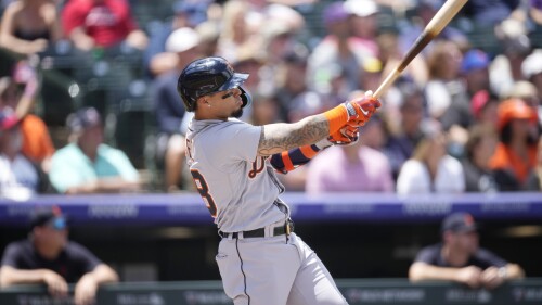 Detroit Tigers' Javier Baez follows the flight of his grand slam off Colorado Rockies starting pitcher Connor Seabold in the first inning of a baseball game Sunday, July 2, 2023, in Denver. (AP Photo/David Zalubowski)