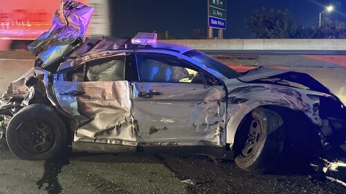 This image released by the Connecticut State Police, Tuesday, July 18, 2023, shows one of of two state police cruisers damaged when human waste, leaking from a tractor trailer, turned Interstate 95 in Bridgeport, Conn., into a virtual skating rink, causing multiple crashes, Monday night, July 17, 2023. State police charged the driver with reckless driving, reckless endangerment and failing to secure a load. (Connecticut State Police via AP)