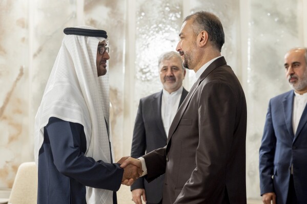 In this photo released by UAE Presidential Court, UAE President Sheikh Mohamed bin Zayed Al Nahyan, greets Hossein Amir Abdollahian, Iran's Minister of Foreign Affairs at Shati Palace in Abu Dhabi, United Arab Emirates, Thursday, June 22, 2023. (Ryan Carter/UAE Presidential Court via AP)