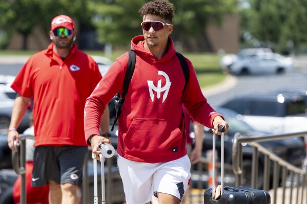 Kansas City Chiefs quarterback Patrick Mahomes wheels his belongings into a dorm room at Missouri Western State University during the first day of NFL football training camp on Tuesday, July 18, 2023, in St. Joseph, Mo. (Nick Wagner/The Kansas City Star via AP)