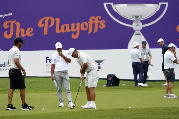 Players work on their game on the practice green at the St. Jude Championship golf tournament Wednesday, Aug. 14, 2024, in Memphis, Tenn. The tournament is scheduled to begin Thursday. (AP Photo/Mark Humphrey)