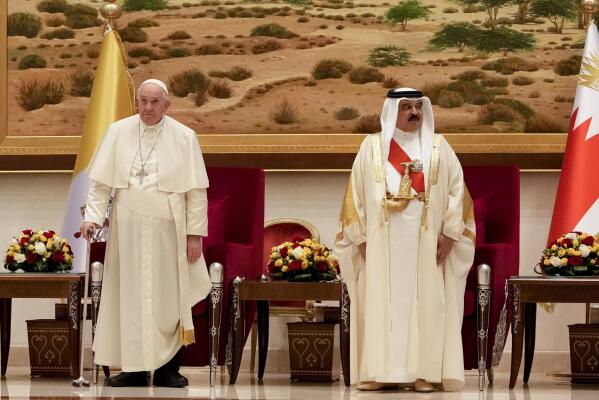 Pope Francis is greeted by Bahrain's King Hamad bin Isa Al Khalifa as he arrives at the Sakhir Royal Palace, Bahrain, Thursday, Nov. 3, 2022. Pope Francis is making the November 3-6 visit to participate in a government-sponsored conference on East-West dialogue and to minister to Bahrain's tiny Catholic community, part of his effort to pursue dialogue with the Muslim world. (AP Photo/Alessandra Tarantino)
